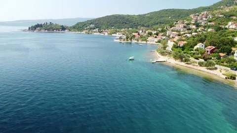 View of a winding mountain road along the coast, cozy houses, beaches, sea Stock Footage 202240911