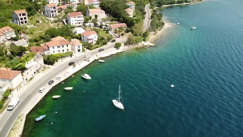 View of a winding mountain road along the coast, cozy houses, beaches, sea Stock Footage 202240922