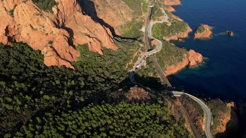 View of a winding road along steep cliffs above the turquoise Mediterranean Sea Stock Footage 319549644