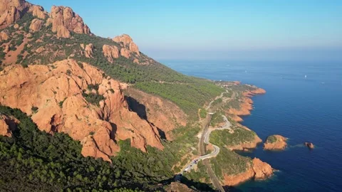 View of a winding road along steep cliffs above the turquoise Mediterranean Sea Stock Footage 319549646