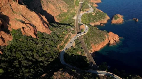 View of a winding road along steep cliffs above the turquoise Mediterranean Sea Stock Footage 319549800