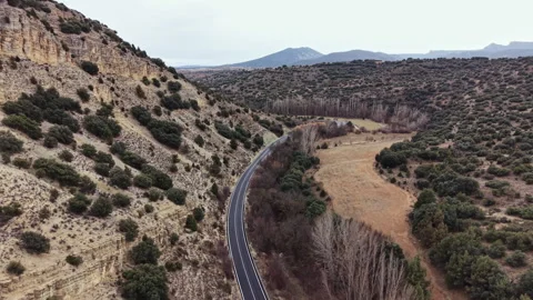 View of a winding road through hills and open fields in a rural area during a Stock Footage 331335535