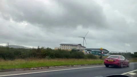 View Of A Windmill And McDonalds From A Car on Cornwall Road Vídeo Stock 221103483