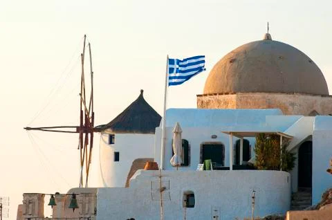 View of windmill and typical house with dome in Santorini Stock Photos