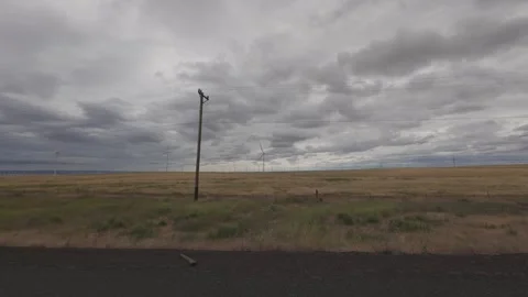 View of windmills in eastern Oregon while driving Stock Footage 312293108