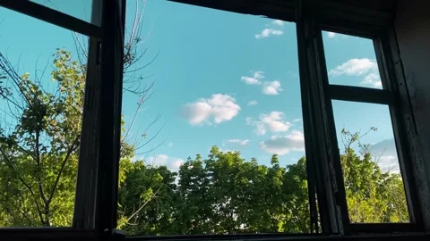 View from the window of an abandoned building to a clear sky Stock Footage 261761838