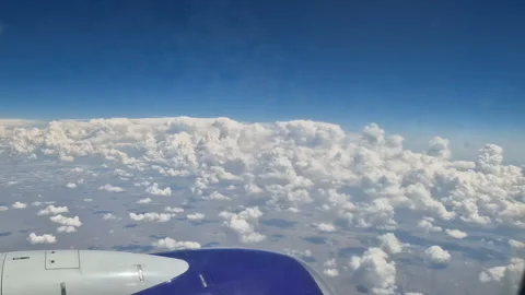 The view from the window of an air plane to the clouds, blue sunny sky. Stock Footage 274268801
