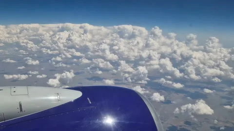 The view from the window of an air plane to the clouds, blue sunny sky. Stock Footage 274269676