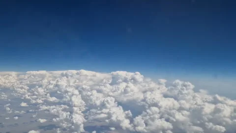 The view from the window of an air plane to the clouds, blue sunny sky. Stock Footage 274270187