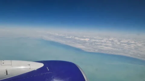 The view from the window of an air plane to the clouds, blue sunny sky. Stock Footage 274272030