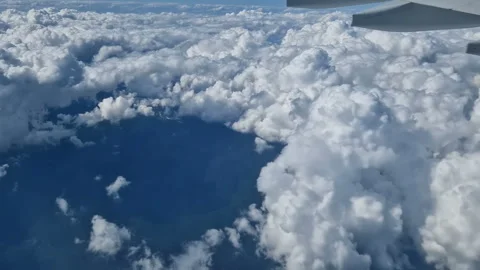 The view from the window of an air plane to the clouds, blue sunny sky. Stock-Footage 274500148