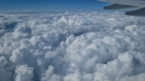 The view from the window of an air plane to the clouds, blue sunny sky. Stock Footage 274500404
