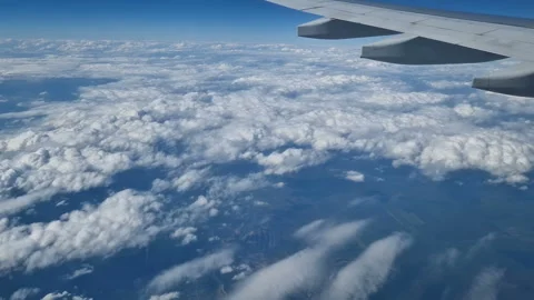 The view from the window of an air plane to the clouds, blue sunny sky. Stock Footage 274890690