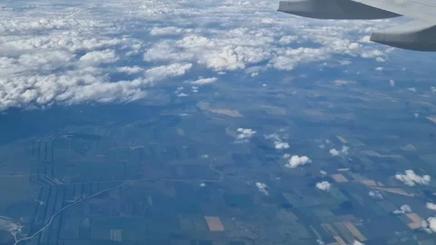 The view from the window of an air plane to the clouds, blue sunny sky. Stock Footage 274892160