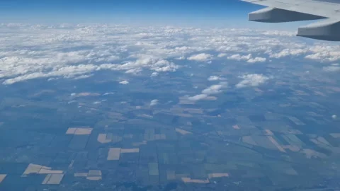 The view from the window of an air plane to the clouds, blue sunny sky. Stock Footage 274892386