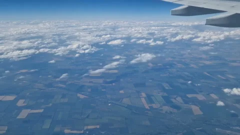 The view from the window of an air plane to the clouds, blue sunny sky. Stock Footage 274892776