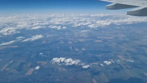 The view from the window of an air plane to the clouds, blue sunny sky. Stock Footage 274893277