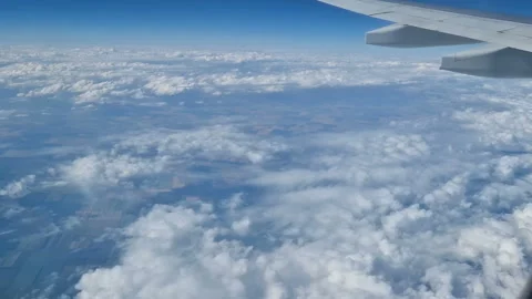 The view from the window of an air plane to the clouds, blue sunny sky. Stock Footage 276104487
