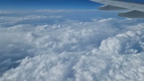 The view from the window of an air plane to the clouds, blue sunny sky. Stock Footage 276104834