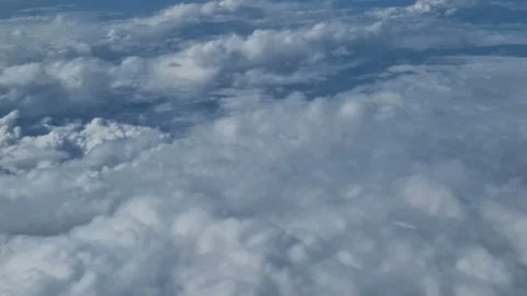 The view from the window of an air plane to the clouds, blue sunny sky. Stock Footage 276105107