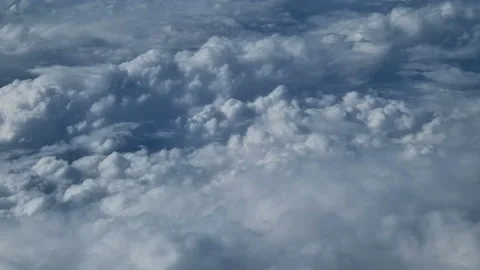 The view from the window of an air plane to the clouds, blue sunny sky. Stock Footage 276105359