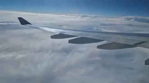 The view from the window of an air plane to the clouds, blue sunny sky. Stock Footage 276106086