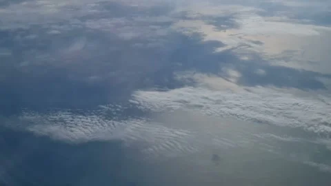 The view from the window of an air plane of clouds and blue sunny sky. Stock Footage 276425414