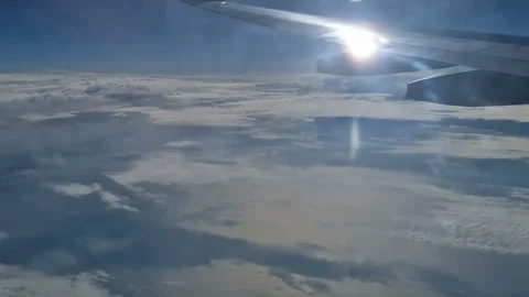 The view from the window of an air plane of clouds and blue sunny sky. Stock Footage 276425692