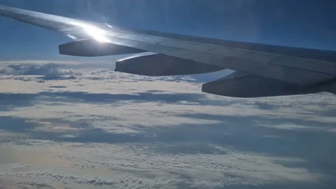 The view from the window of an air plane of clouds and blue sunny sky. Stock Footage 276426256