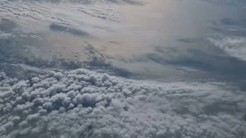 The view from the window of an air plane of clouds and blue sunny sky. Stock Footage 276741092