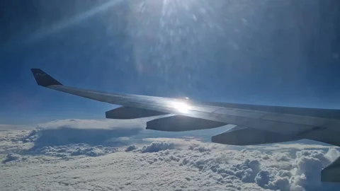 The view from the window of an air plane of clouds and blue sunny sky. Stock Footage 276741391