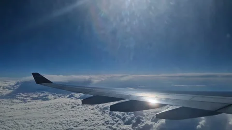 The view from the window of an air plane of clouds and blue sunny sky. Stock Footage 276741596