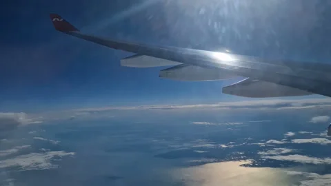 The view from the window of an air plane of clouds and blue sunny sky. Stock Footage 277438200