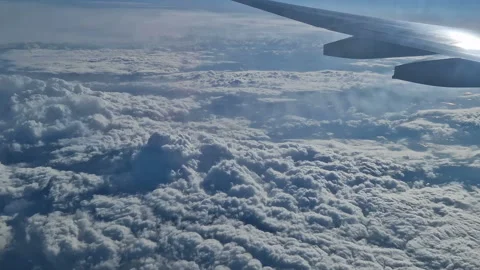 The view from the window of an air plane of clouds and blue sunny sky. Stock Footage 277438741