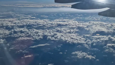 The view from the window of an air plane of clouds and blue sunny sky. Stock Footage 277563981