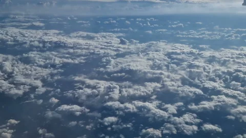 The view from the window of an air plane of clouds and blue sunny sky. Stock Footage 277565030