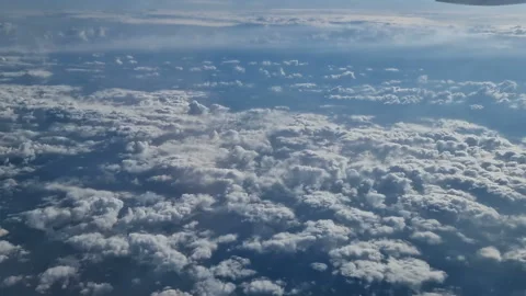 The view from the window of an air plane of clouds and blue sunny sky. Stock Footage 277565414