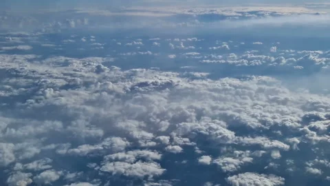 The view from the window of an air plane of clouds and blue sunny sky. Stock Footage 277623271