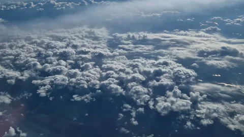 The view from the window of an air plane of clouds and blue sunny sky. Stock Footage 277623978