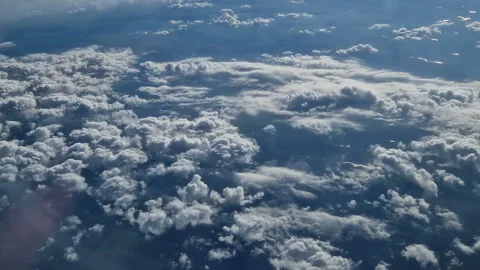 The view from the window of an air plane of clouds and blue sunny sky. Stock Footage 277624255