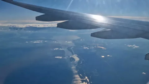 The view from the window of an air plane of clouds and blue sunny sky. Stock Footage 277809899