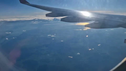 The view from the window of an air plane of clouds and blue sunny sky. Stock Footage 277810588