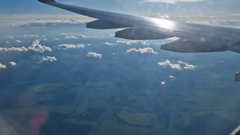 The view from the window of an air plane of clouds and blue sunny sky. Stock Footage 277812739