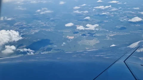 The view from the window of an air plane of clouds and blue sunny sky. Stock Footage 311762690