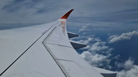 The view from the window of an air plane of clouds and blue sunny sky. Stock Footage 311762696