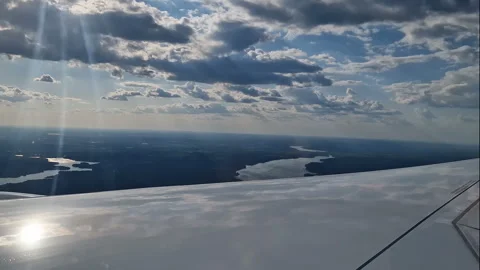 The view from the window of an air plane of clouds and blue sunny sky. Stock Footage 311762756