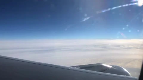 View from the window of the aircraft. Beautiful view of the clouds through the Stock Footage 204854226