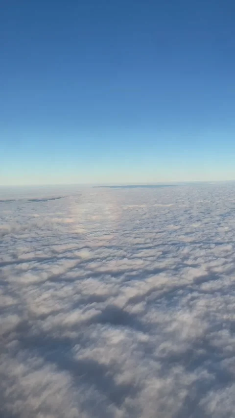 View from the window of the aircraft on clouds and a circular rainbow Stock Footage 170858461
