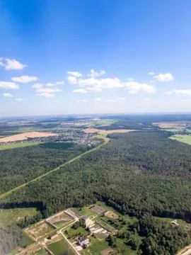 View from the window of the aircraft: forests, roads, towns and cities Stock Photos