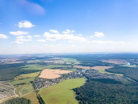 View from the window of the aircraft: forests, roads, towns and cities Stock Photos
